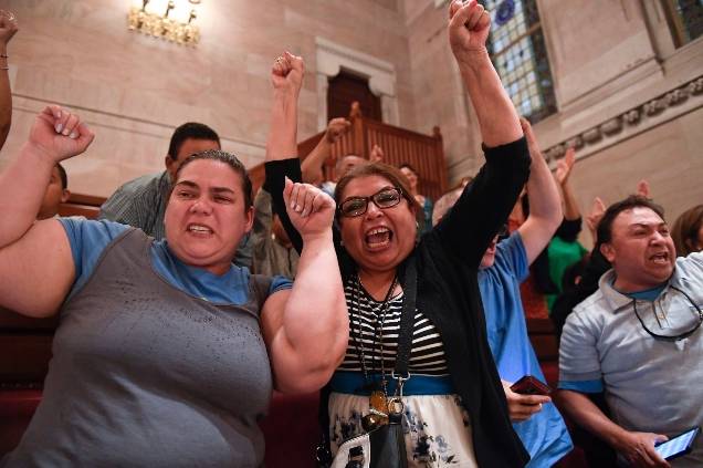 Spectators celebrate after legislation sponsoring the Green Light Bill granting undocumented Immigrant driver's licenses was passed by the Senate during a Senate session at the state Capitol, in Albany, N.Y